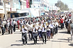 Salvation Band Matunda lead Scouts in a procession during Founders Day celebrations