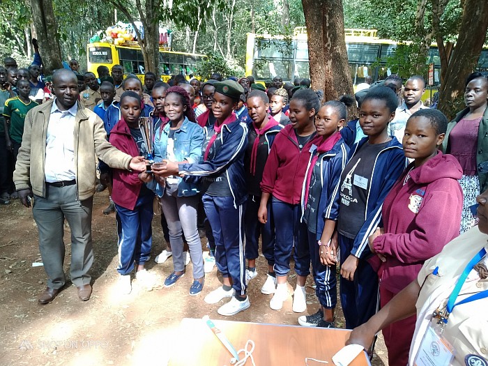 CSC Mr. Richard Openda shakes hands with Patrol Leader of Kapkoiga Girls' High School after emerging winners in 2019 national badge camp held at Rowallan camp in Nairobi