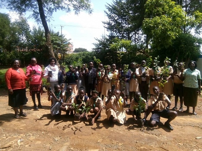 Sosiani Primary School Scouts pose for a group photo with their scout leaders and the CSC Mr. Richard Openda in preparation of tree planting in their school. A total of 200 tress were planted